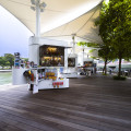 Kiosks with existing tensile canopy structures
